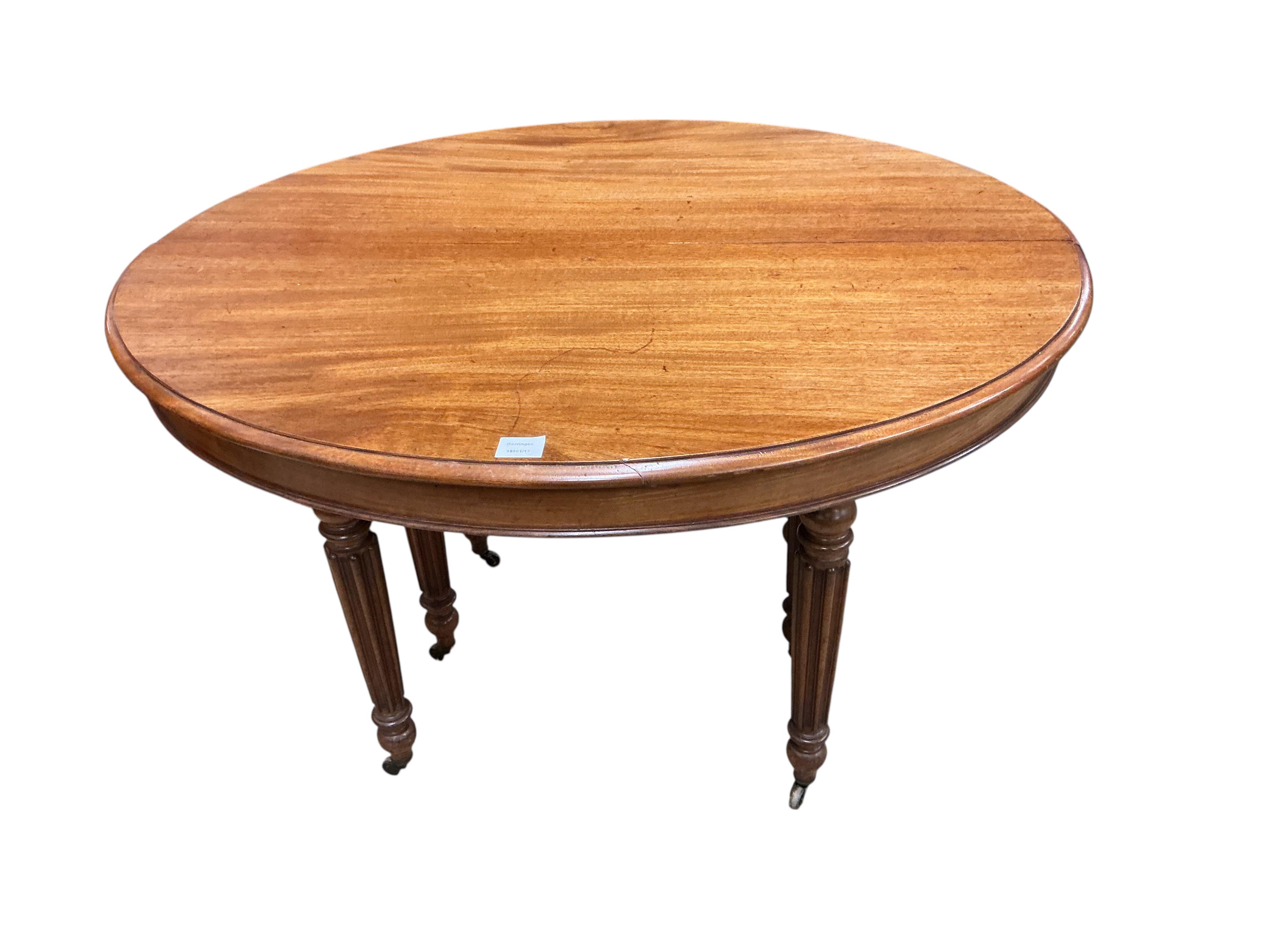 A 19th century French oval mahogany extending dining table, length 214cm extended, two spare leaves, width 102cm, height 70cm